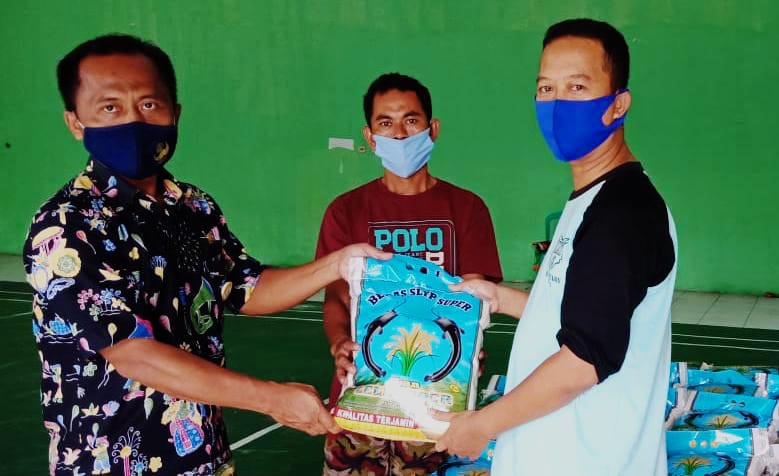 Kasi Kesos Kelurahan Kaliabang Tengah Sulaiman kiri simbolis memberikan bantuan beras