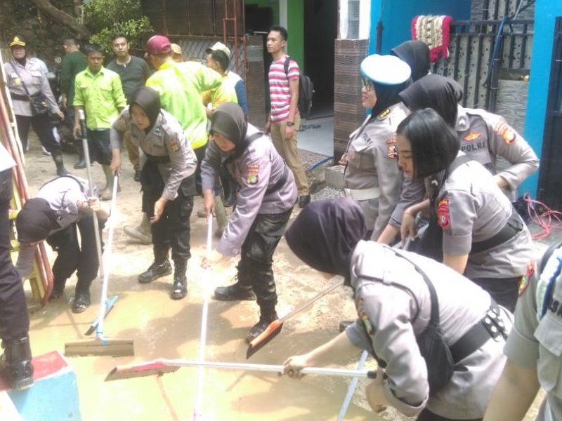 Polwan gabungan membersihkan sisa lumpur dan sampah usai banjir di Kota Bekasi