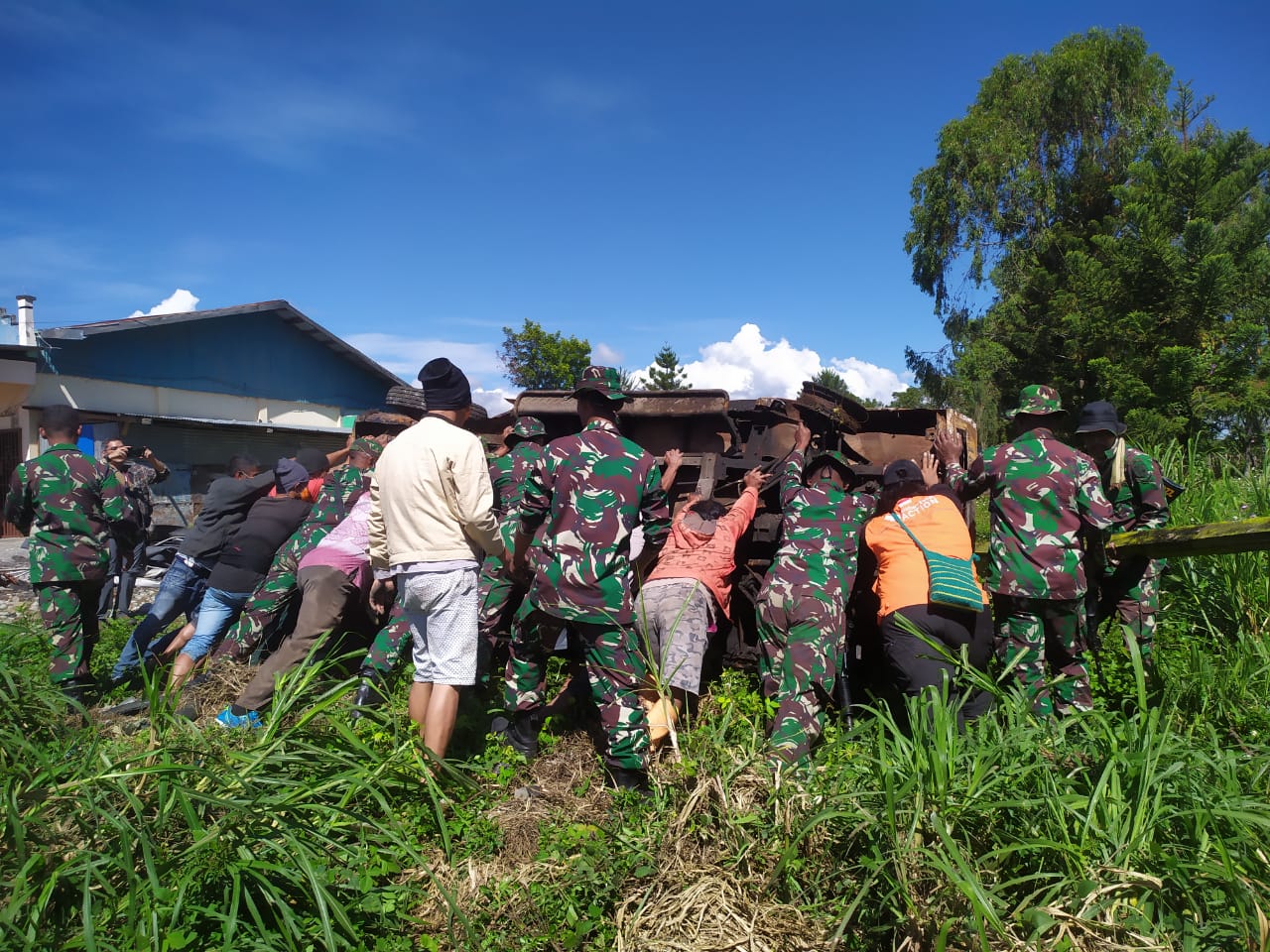 Tim Relawan Rumah Zakat bersama TNI membersihkan puing puing bangunan yang rusak di Wamena